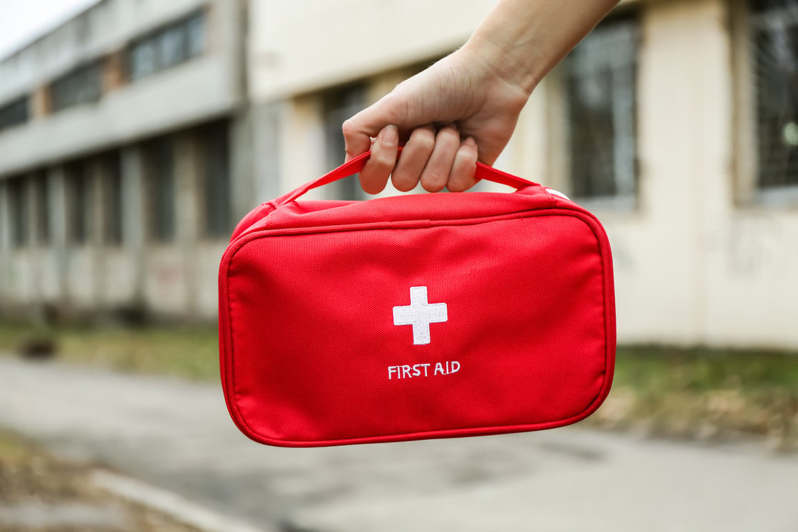 Woman with First Aid Kit Outdoors