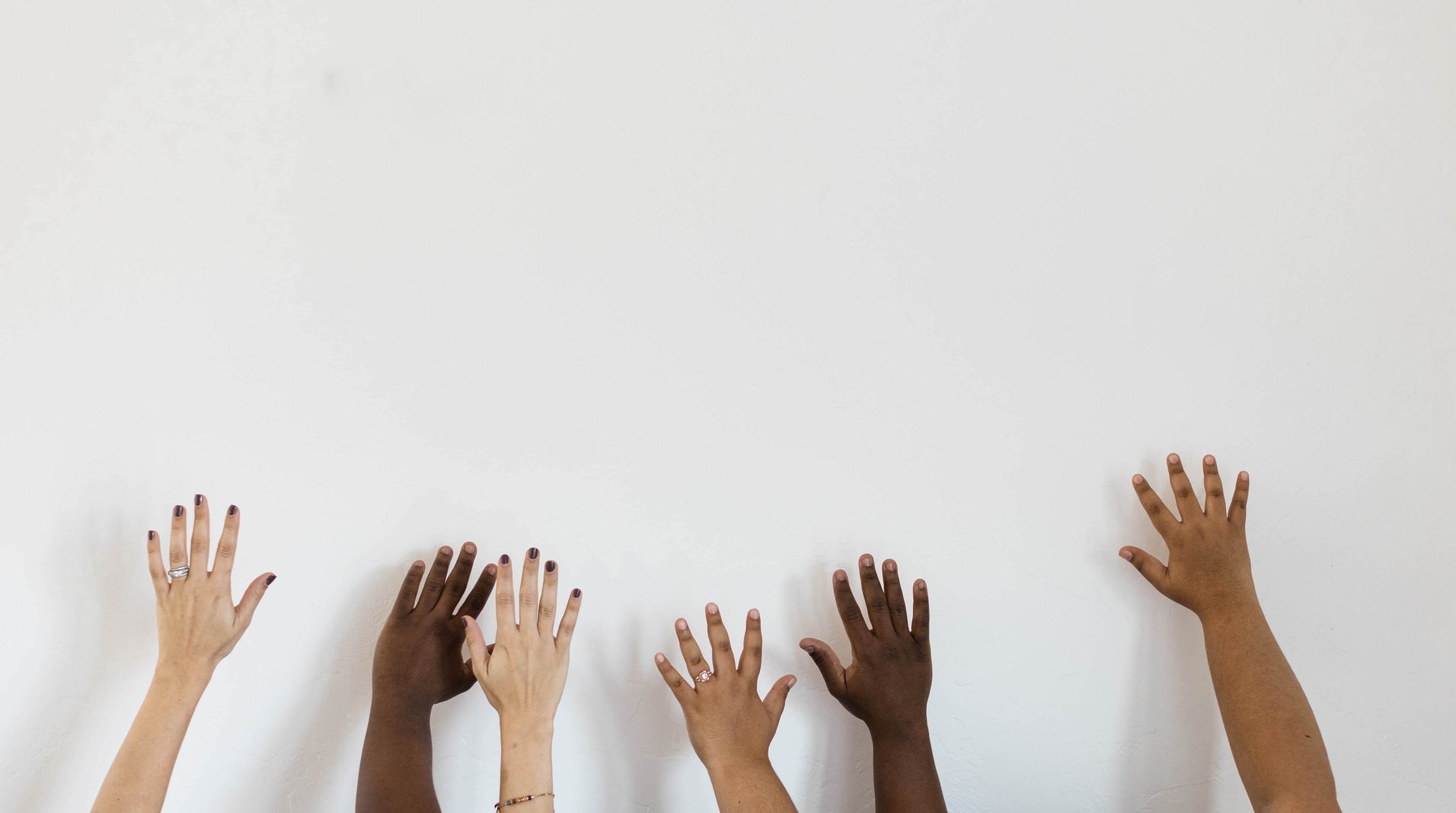 Diverse Hands Raised in the Air on White Background